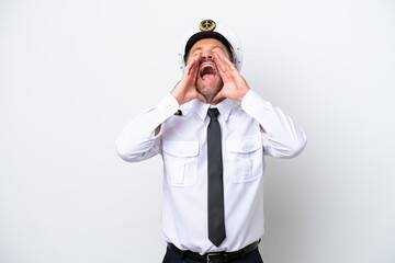 Airplane middle age pilot isolated on white background shouting and announcing something