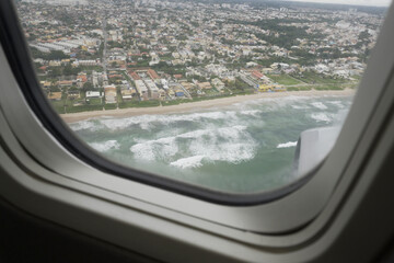 Fototapeta premium Ocean View from Airplane Window View. Travel and Destination Concepts.