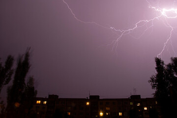 Lightning at night with heavy rain and thunder over Ukraine, lightning over the city in the night sky