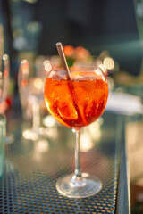Wine glasses of fresh aperol spritz cocktails on the served table in a street summer cafe.