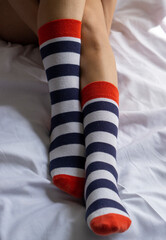 Obraz premium woman legs in color red, blue and white socks