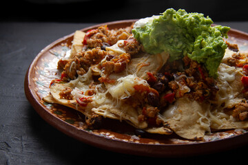 Nachos with guacamole and chilli con carne. Mexican food
