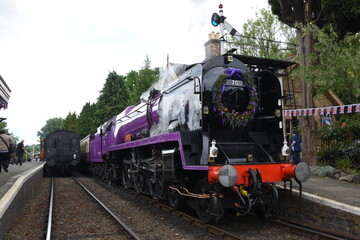 the taw valley re painted purple to celebrate the queens platinum jubilee traveling through Hampton Loade on its first trip since being re-named