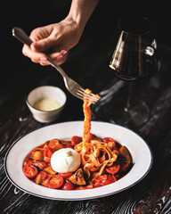 Appetizing Italian pasta with cheese on a dark wooden background