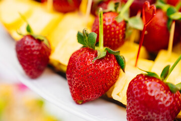 beautiful and original serving of strawberries in pineapple on the festive table