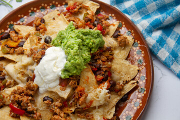 Nachos with guacamole and chilli con carne. Mexican food