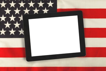 Blank screen digital tablet against american flag in background.