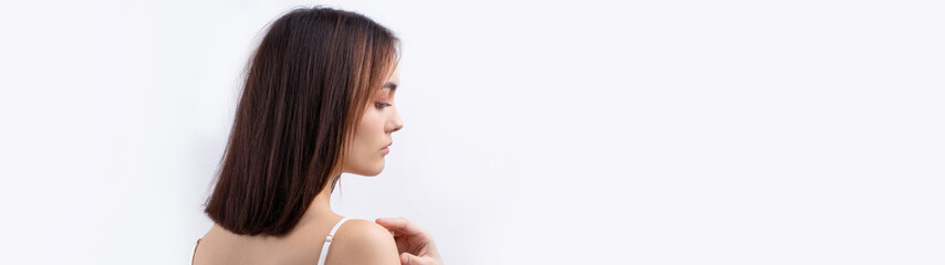 Naklejka premium Beautiful smiling woman with clean skin, natural make-up and white teeth on a gray background