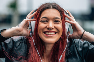 woman smiling happy with headphones listening to music