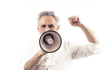 Middle-aged caucasian male protester is angry, loudly shouts via loudspeaker, and throws his fist in the air. Isolated over white background. High quality photo