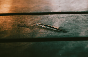 a plastic table with a burnt piece. close up on burnt plastic table. cinematic look