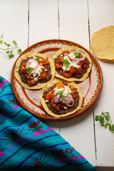 picadillo corn tostadas with cheese and beans. Mexican food
