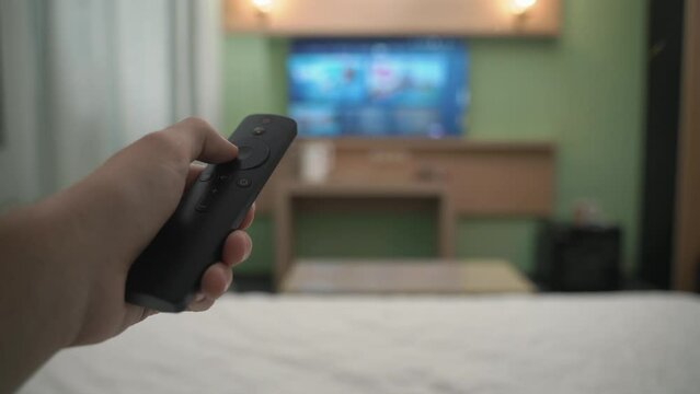 Hand swipes smart tv with a remote controller