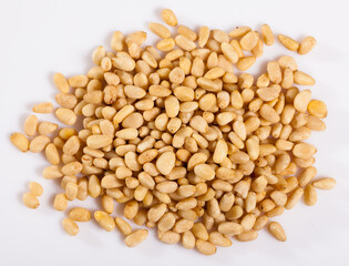 Fototapeta premium Pile of delicious pine nuts on a white surface. High quality photo