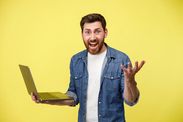 Emotional man holding a laptop and shouting actively gesturing with his hands