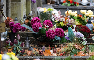 All Saints' Day, burning candles and flowers on the graves. Catholic cemetery during All Saints' Day. Candles on graves symbolize the memory of the dead on November 1.