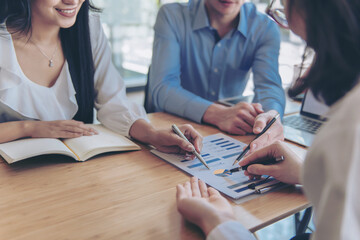 Business meeting, man's hands pointing on charts. Reflection light and flare. Concept image of data...