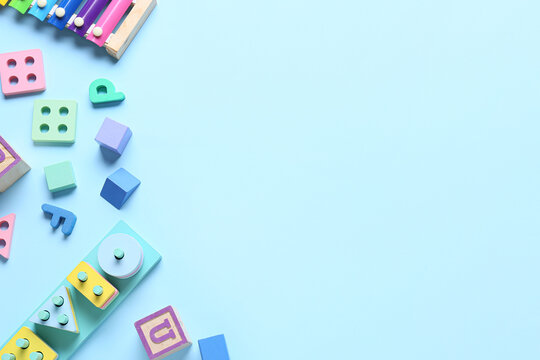 Children building blocks on blue background