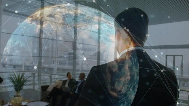 Animation of connections and globe over back of caucasian businessman