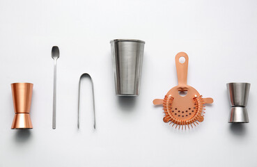 Different bartender tools on grey background