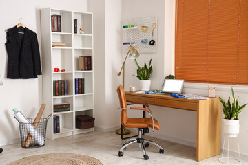Interior of modern studio with workplace of clothes stylist
