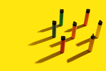 Disposable electronic cigarettes on yellow background