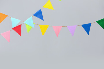 Colorful flags for Festa Junina on grey background