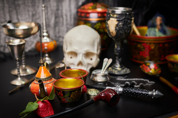Magical items placed on the table, ready for the use of evil dark magic: skull, goblet, wand