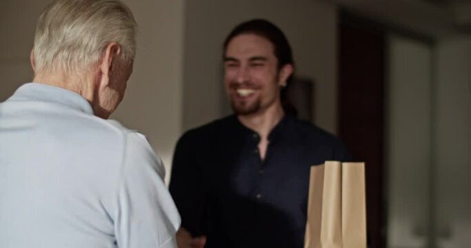 Senior dad greeting visiting son