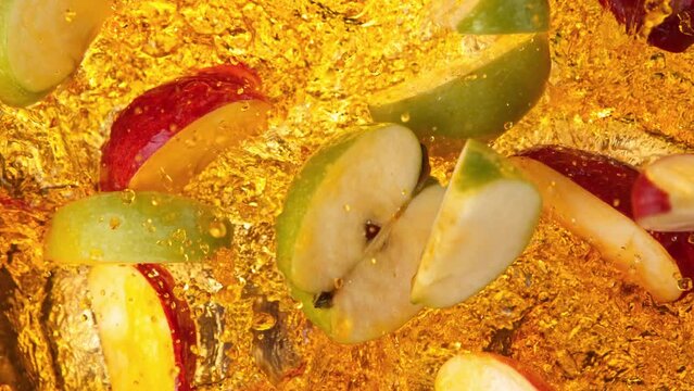 Super Slow Motion Shot of Red and Green Apple Cuts Falling and Splashing into Juice at 1000fps.