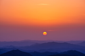 Fototapeta premium Scenic view of mountains against sky during sunrise