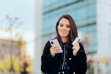 Fototapeta premium Happy Woman Holding Credit Card and Smartphone Buying Online