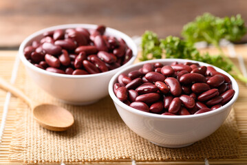 Red kidney beans in bowl on wooden table, Food ingredients