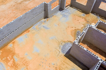 Aerial top view of unfinished blocks concrete foundation for new houses