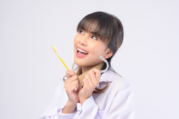 Young female dentist smiling over white background studio