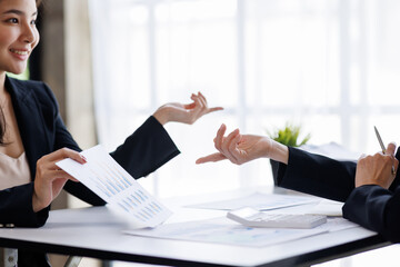 Team of Asian Businessman working at office with documents on his desk, doing planning analyzing the financial report, business plan investment, finance analysis concept