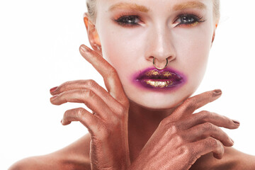 Beauty model female with bright fashion make-up touches face with fingers.
