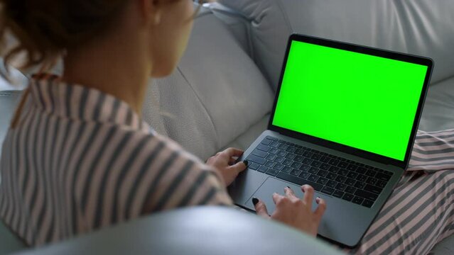 Woman looking green screen laptop at remote workplace closeup. Girl browsing web