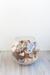 bouquet of dry flowers and potpourri in a glass jar on a white table. High quality photo.