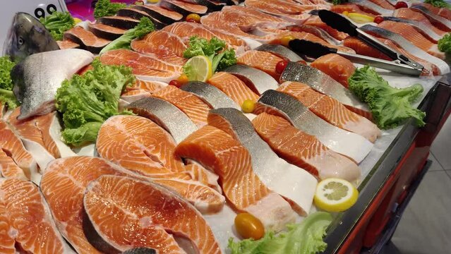 Close-up view of the fresh fjord trout fillet on the ais selling in the supermarket.