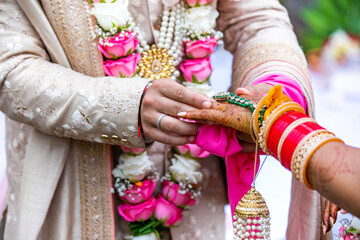 Fototapeta na wymiar Indian couple's ring exchange hands close up