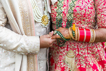 Fototapeta na wymiar Indian married couple's holding hands close up