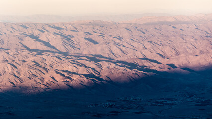 The valley of Palm Springs landscape in fall on a hazy, warm afternoon from aerial, above shot.	