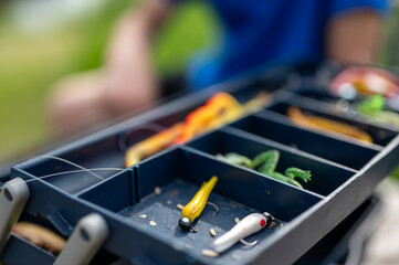 Selective focus on lure inside an open fishing tackle box. 