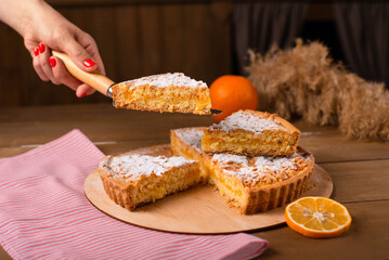 a piece of sliced pie on a spatula in the girl's hand