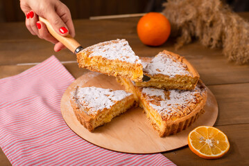 a piece of sliced pie on a spatula in the girl's hand
