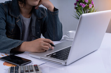 Business woman working and watching the computer bored. Woman typing on her computer making use of technology. Stressed woman. Finger pressing on touchpad while her bored. lazy work.