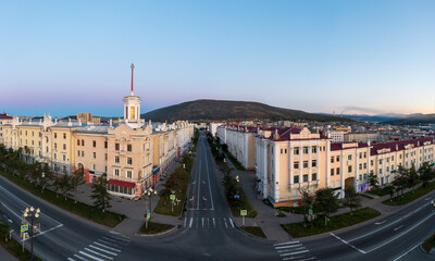 Fototapeta premium Aerial view of the city of Magadan. Streets and buildings in the historical center of the city. Beautiful old tower with a spire. View of Portovaya street. Magadan, Magadan region, Russian Far East.
