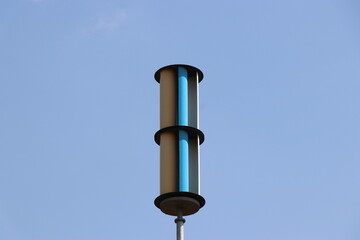 Vertical axis wind turbine or VAWT with blue sky in the background