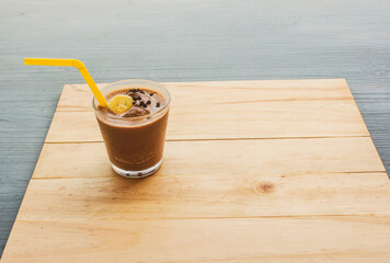 Chocolate banana smoothie topping sprinkled with chocolate chips banana slices 
